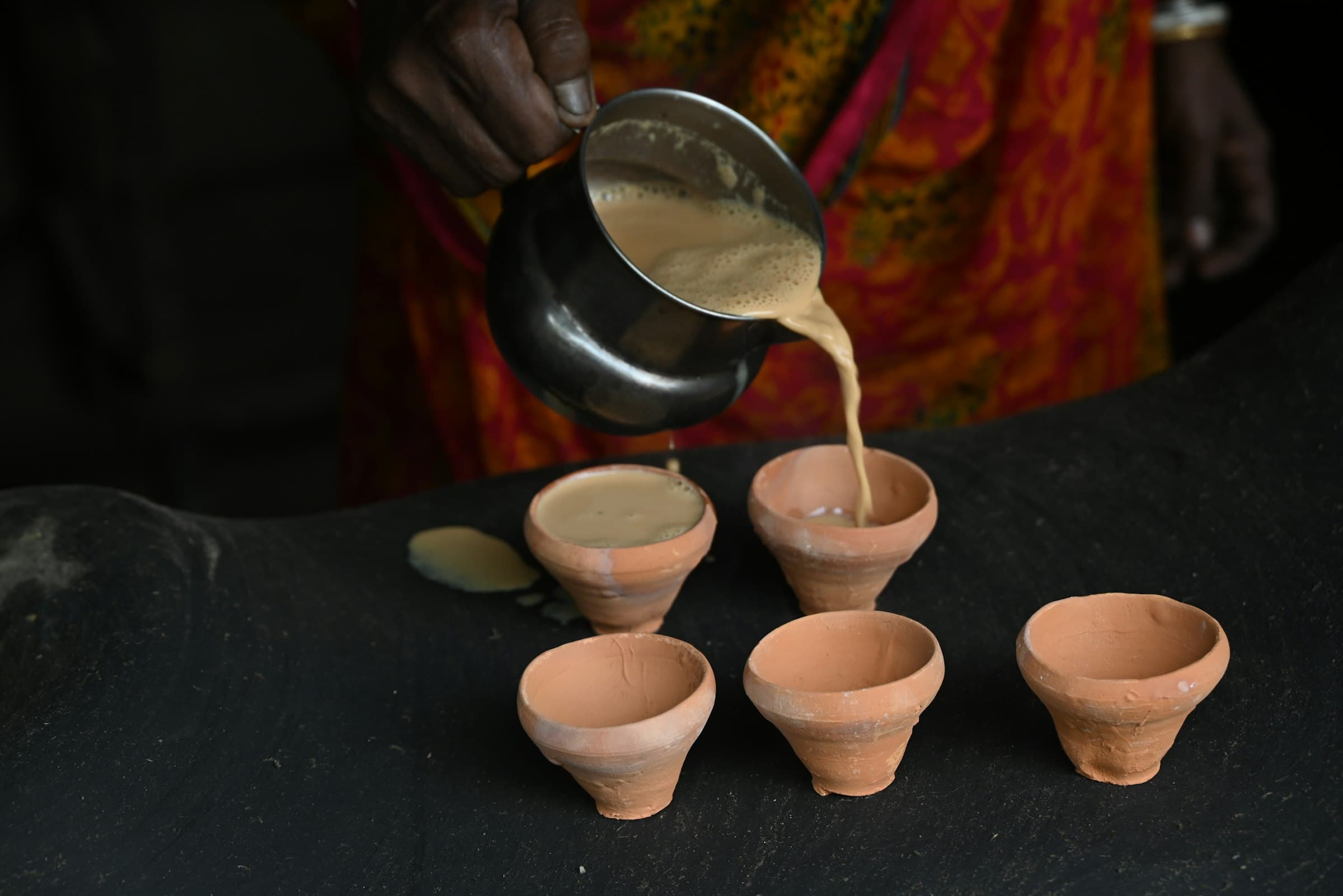 Chai being poured into clay kulhads